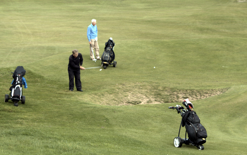 A brave chip over the bunker at the 8th by Mike Keith